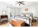 Comfortable bedroom with a ceiling fan, a decorative trunk, side table, and lots of natural light at 812 E Ponce De Leon Ave, Decatur, GA 30030