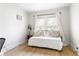 Minimalist bedroom with hardwood floors, natural light, and neutral decor creating a calming space at 812 E Ponce De Leon Ave, Decatur, GA 30030