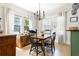 Cozy dining room features hardwood floors, neutral paint, bright windows, and stylish modern chandelier at 812 E Ponce De Leon Ave, Decatur, GA 30030