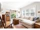 Cozy living room with hardwood floors, comfortable seating, and an open view to backyard at 812 E Ponce De Leon Ave, Decatur, GA 30030