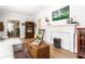 Bright living room featuring a fireplace, comfortable seating, and view into other rooms at 812 E Ponce De Leon Ave, Decatur, GA 30030