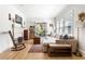 Bright living room features a fireplace, wood floors, and french doors to outdoor porch at 812 E Ponce De Leon Ave, Decatur, GA 30030
