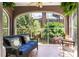 Relaxing screened porch featuring brick columns, a comfortable blue sofa, and views of the backyard at 812 E Ponce De Leon Ave, Decatur, GA 30030