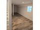 Finished basement with wood-look tile flooring, staircase and access to the outside at 2065 Verbena St, Atlanta, GA 30314