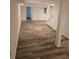 Spacious basement with wood-look tile flooring, white support beams, and stairs at 2065 Verbena St, Atlanta, GA 30314