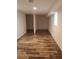 Finished basement with wood-look floors, white walls, and columns at 2065 Verbena St, Atlanta, GA 30314