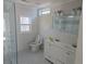 Modern bathroom with glass shower, double vanity, tile walls, and window at 2065 Verbena St, Atlanta, GA 30314