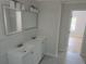 Bathroom featuring a double vanity, sinks, and an open doorway at 2065 Verbena St, Atlanta, GA 30314