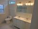 Bathroom featuring a shower, double vanity, toilet, and a window at 2065 Verbena St, Atlanta, GA 30314