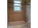 Bathroom featuring a bathtub with tile surround at 2065 Verbena St, Atlanta, GA 30314