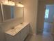 Bathroom featuring a double vanity, sinks, and an open doorway at 2065 Verbena St, Atlanta, GA 30314