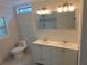Bathroom featuring a shower, double vanity, toilet, and a window at 2065 Verbena St, Atlanta, GA 30314