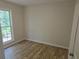 Bright bedroom with a large window and neutral walls, featuring laminate floors at 2065 Verbena St, Atlanta, GA 30314
