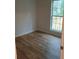 Bedroom with wood-look flooring and a window overlooking a deck at 2065 Verbena St, Atlanta, GA 30314