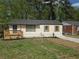 Inviting one-story home with a small porch, new landscaping, and a well-manicured lawn at 2065 Verbena St, Atlanta, GA 30314
