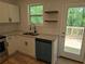 Modern kitchen features granite countertops, stainless steel appliances, and access to an outdoor deck at 2065 Verbena St, Atlanta, GA 30314