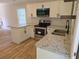 Stylish kitchen featuring white cabinets, granite countertops, and stainless steel appliances at 2065 Verbena St, Atlanta, GA 30314