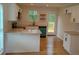 Kitchen with white cabinets, granite counters, stainless appliances and an exterior door at 2065 Verbena St, Atlanta, GA 30314