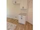 Bright kitchen boasts white cabinets, granite countertops, and hardwood flooring at 2065 Verbena St, Atlanta, GA 30314