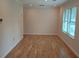 Living room with wood-look floors and a bright window for natural light at 2065 Verbena St, Atlanta, GA 30314