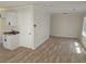 Open concept living room with wood-look floors, view of kitchen and a bright window at 2065 Verbena St, Atlanta, GA 30314