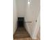 Stairway leading to basement with handrail and wood-look floors at 2065 Verbena St, Atlanta, GA 30314