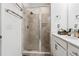 Bathroom showcasing a glass-enclosed shower, towel racks, and a vanity with marble countertops at 3533 Settlement Rd, Tucker, GA 30084