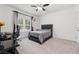 Bedroom featuring a gray bed, ceiling fan, window with curtains, and a neutral-colored carpet at 3533 Settlement Rd, Tucker, GA 30084