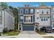 Charming three-story townhouse with a dark-blue facade and a balcony above the garage at 3533 Settlement Rd, Tucker, GA 30084