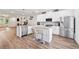 Bright, open kitchen featuring a large island, stainless steel appliances, and a breakfast bar at 3533 Settlement Rd, Tucker, GA 30084