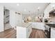 Open kitchen featuring stainless steel appliances, granite countertops, and hardwood floors at 3533 Settlement Rd, Tucker, GA 30084