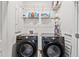 Laundry room featuring a front load washer and dryer with wire shelving for storage at 3533 Settlement Rd, Tucker, GA 30084