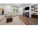 Spacious living room with a fireplace, recessed lights and doors to the balcony at 3533 Settlement Rd, Tucker, GA 30084