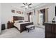 Main bedroom featuring a wooden bed, ceiling fan, carpet, and two windows with curtains at 3533 Settlement Rd, Tucker, GA 30084