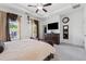 Main bedroom featuring a bed, ceiling fan, carpet, television, and windows with curtains at 3533 Settlement Rd, Tucker, GA 30084