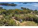 Aerial view of a home surrounded by lush trees and situated on a beautiful lake, showcasing its peaceful setting at 4725 Young Deer Dr, Cumming, GA 30041