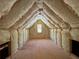 Well-insulated attic space featuring exposed wooden beams and a small window, great for storage or potential living space at 4725 Young Deer Dr, Cumming, GA 30041
