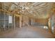 Unfinished basement with exposed framing, plumbing, and door to the outside, providing ample room for future development at 4725 Young Deer Dr, Cumming, GA 30041