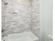 Lovely white and gray shower with gray patterned tile and built in shower niche at 4725 Young Deer Dr, Cumming, GA 30041