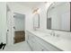 Bright bathroom featuring double vanity sinks with white countertops and large framed mirrors at 4725 Young Deer Dr, Cumming, GA 30041