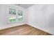 Bright bedroom featuring wood floors, two windows, and white trim at 4725 Young Deer Dr, Cumming, GA 30041