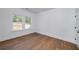This bedroom features beautiful hardwood floors, light bright walls, and natural light from two windows at 4725 Young Deer Dr, Cumming, GA 30041