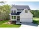 Charming two-story home with white siding, a well-manicured lawn, and an attached two-car garage at 4725 Young Deer Dr, Cumming, GA 30041