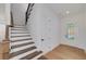 Foyer featuring wood stairs, coat closet, and light wood flooring at 4725 Young Deer Dr, Cumming, GA 30041