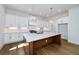 Stylish kitchen features a spacious island, ample cabinet space, and modern lighting fixtures, creating a functional and elegant space at 4725 Young Deer Dr, Cumming, GA 30041