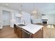 Well-designed kitchen with stainless steel appliances and an open view to the fireplace in the living room at 4725 Young Deer Dr, Cumming, GA 30041