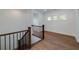 Upstairs landing features wood floors and railing at 4725 Young Deer Dr, Cumming, GA 30041