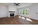 Bright living room with a cozy fireplace, complemented by large windows that fill the space with natural light and warmth at 4725 Young Deer Dr, Cumming, GA 30041