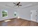Main bedroom featuring a tray ceiling, wood floors, and two windows at 4725 Young Deer Dr, Cumming, GA 30041