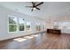 Open floor plan features hardwood floors, seamless transition from living area to kitchen, and abundant natural light through large windows at 4725 Young Deer Dr, Cumming, GA 30041